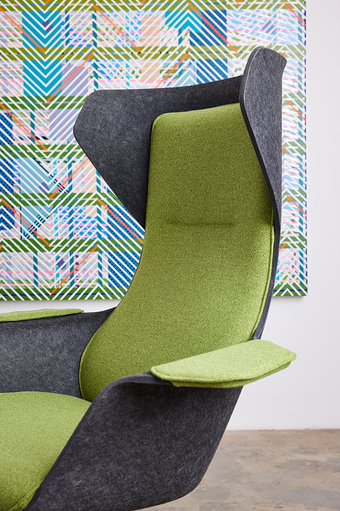 Vooom chair in green fabric in an art gallery