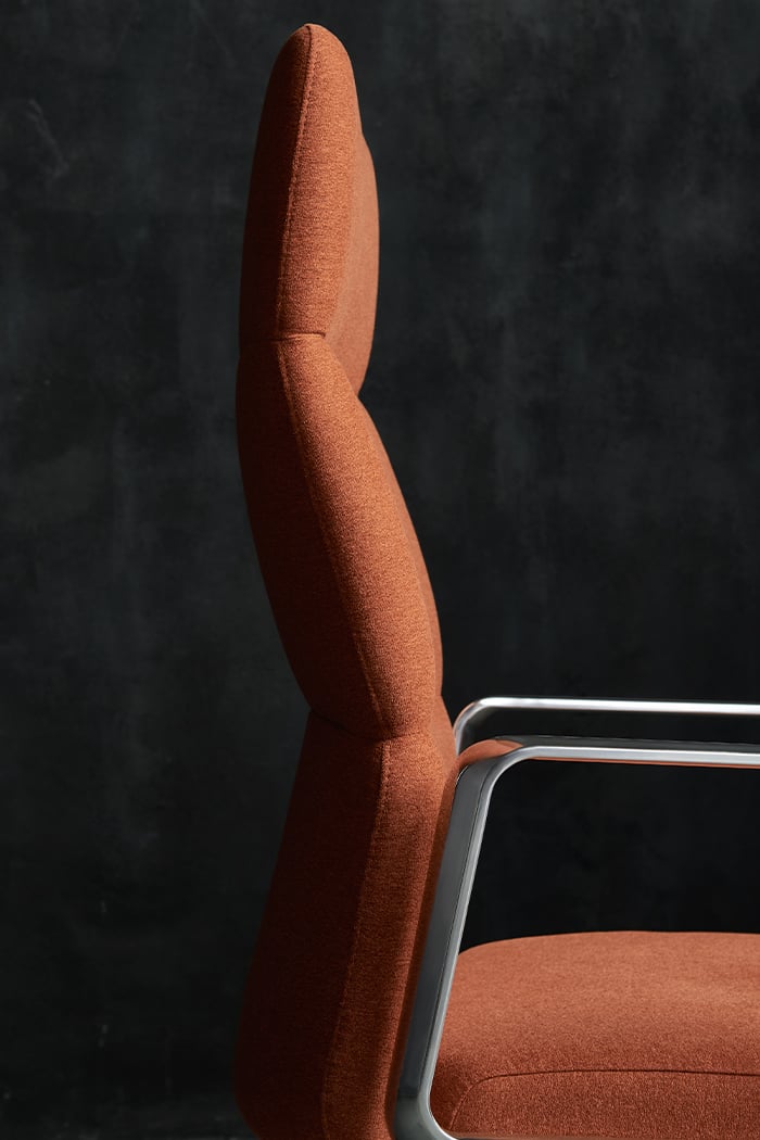 Vero high back close up with polished loop arm & a burnt orange suede