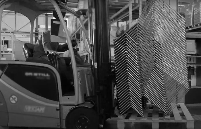 A crane loads a stack of high-density stackable Splash frames onto a pallet